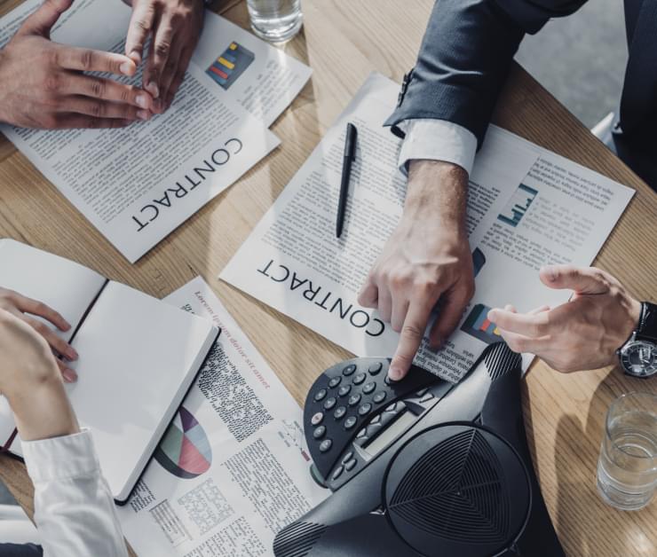 People starting a teleconference over contractual documents
